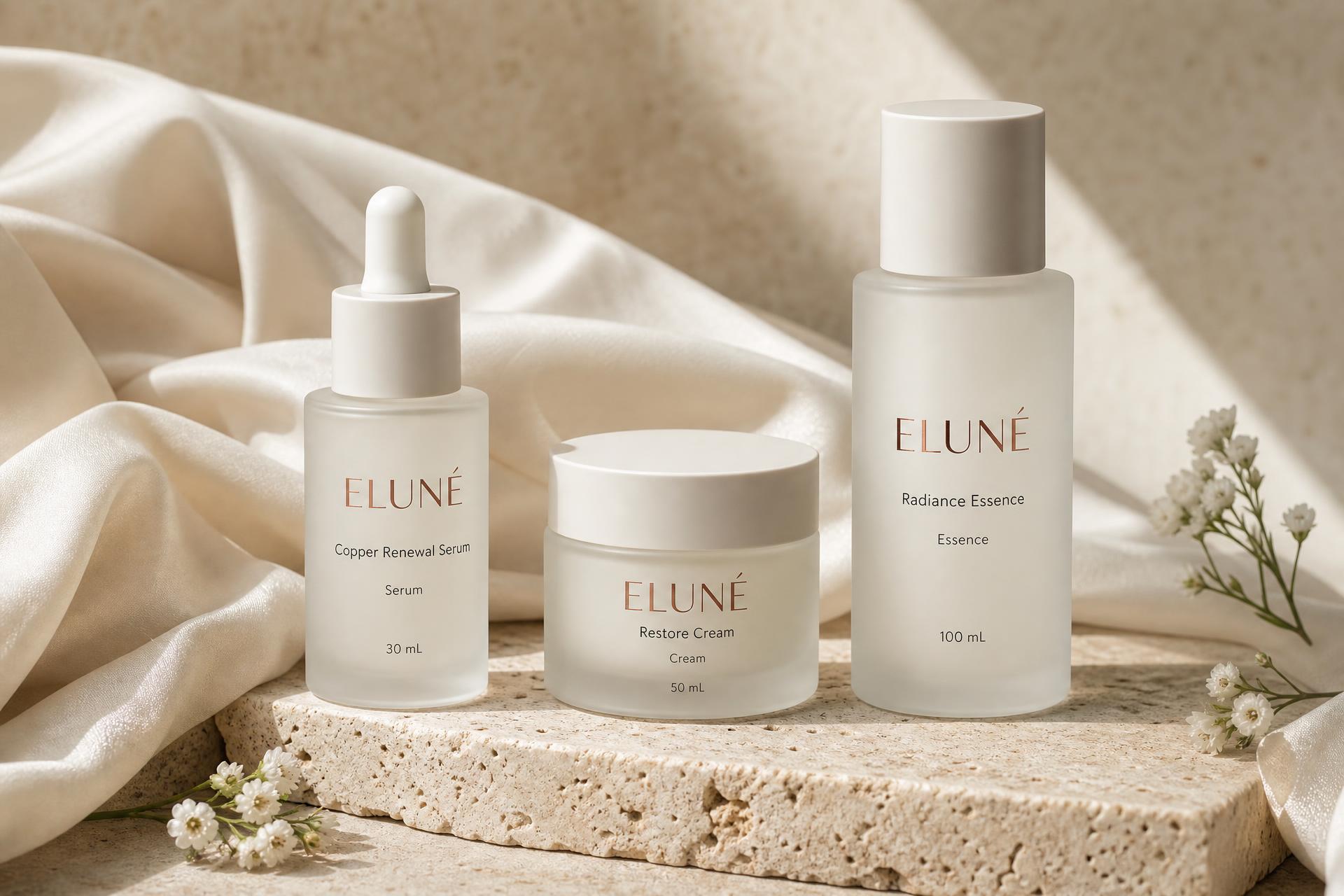 ELUNÉ Copper Renewal Serum, Restore Cream and Radiance Essence on travertine stone in soft morning light